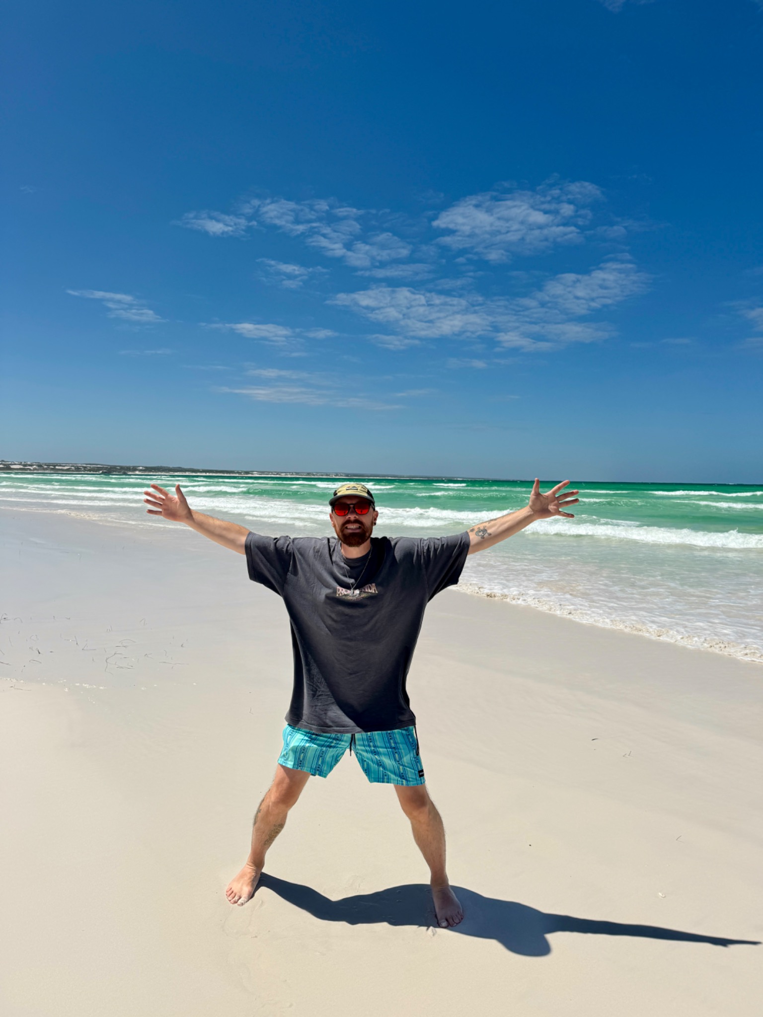 Ash standing on a beach